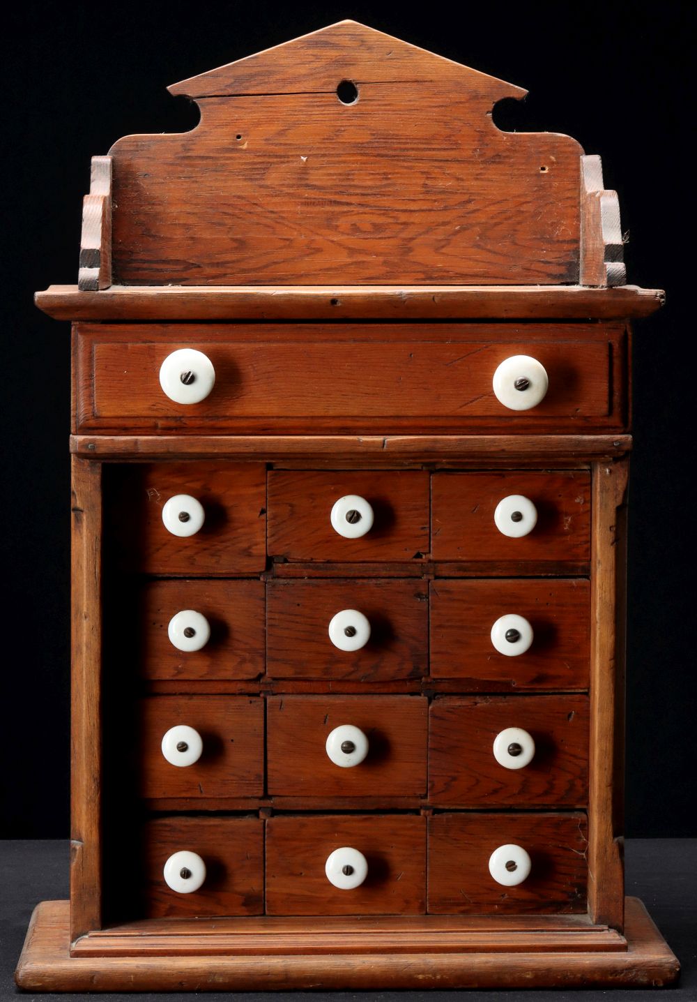 A PINE THIRTEEN DRAWER SPICE CABINET CIRCA 1890