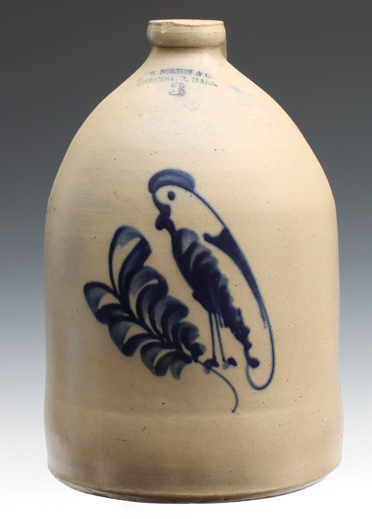 A BLUE DECORATED STONEWARE JUG SIGNED F.B. NORTON & CO.