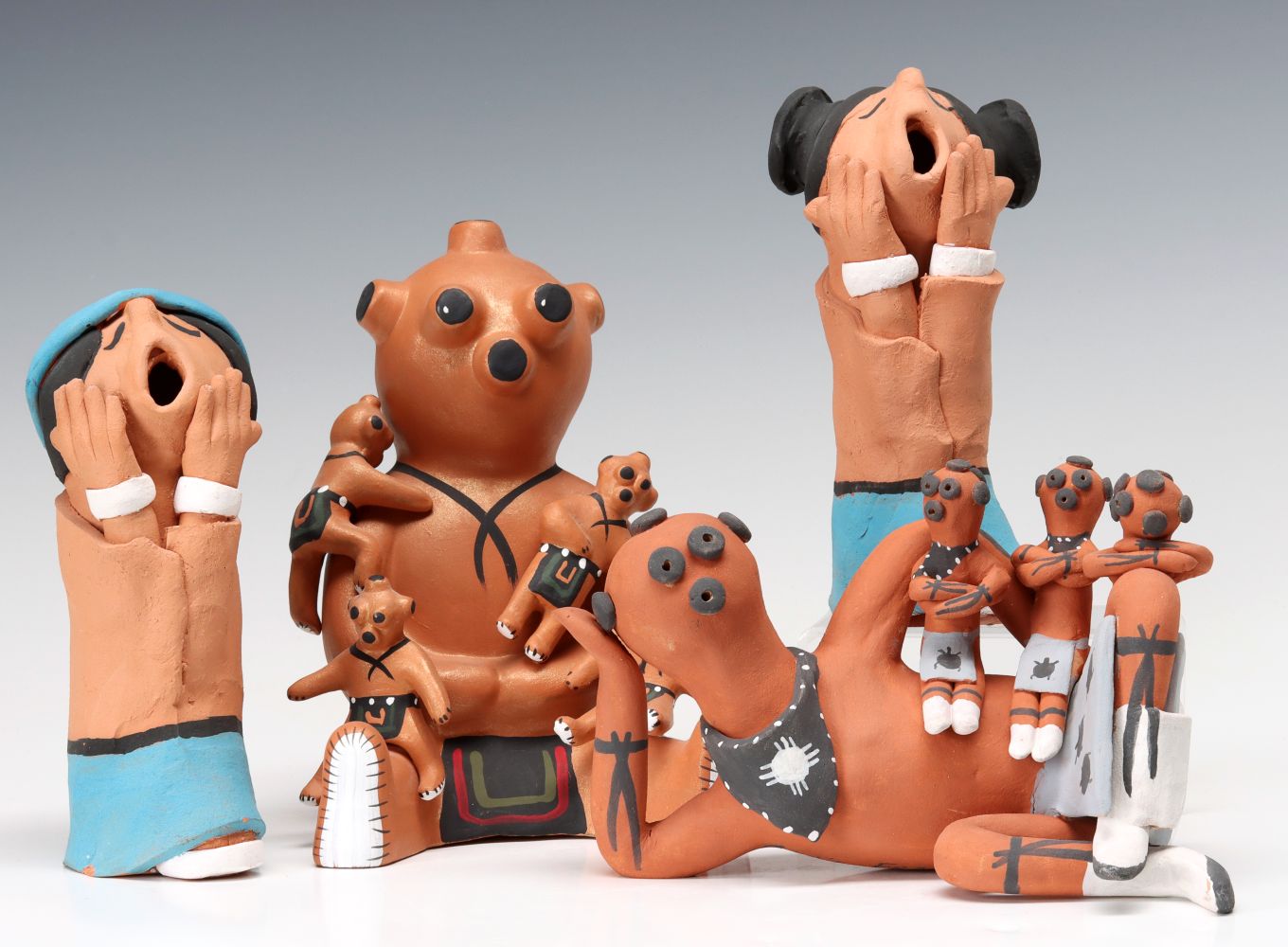 FOUR MUDHEAD AND STORYTELLER PUEBLO POTTERY FIGURES