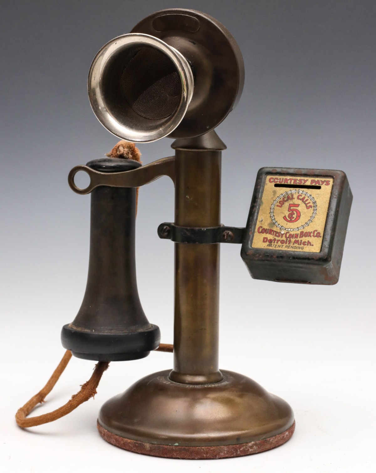 AN EARLY 20TH C. CANDLESTICK PHONE WITH 5Â¢ PAY BOX