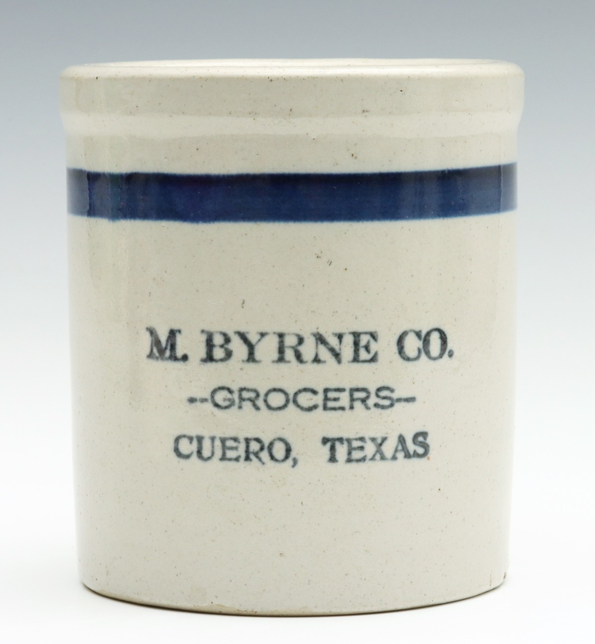 A CUERO, TEXAS ADVERTISING STONEWARE BEATER JAR