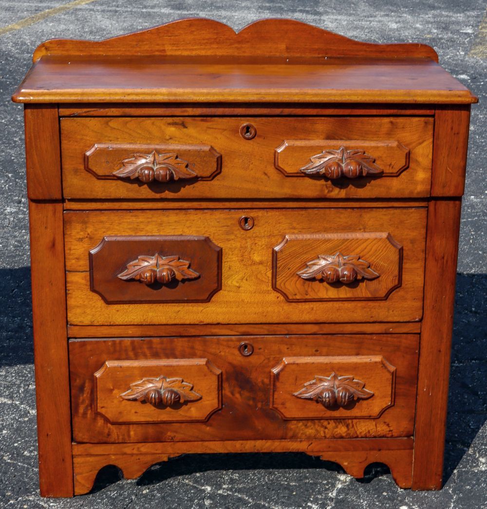 AN ANTIQUE THREE DRAWER WALNUT WASH STAND