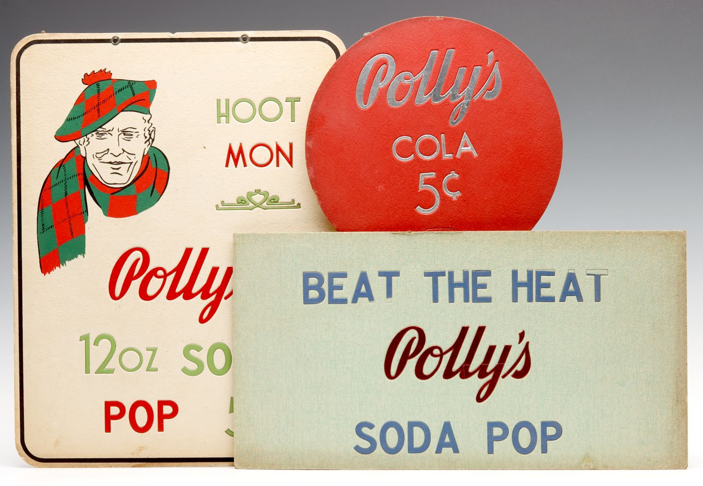 A COLLECTION OF POLLY'S SODA POP ADVERTISING SIGNS