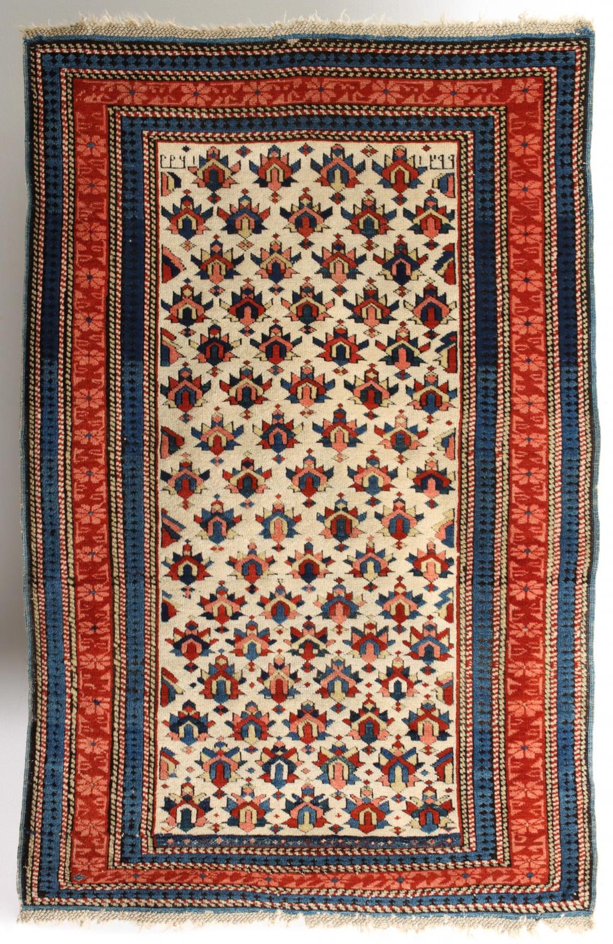 A VERY FINE IVORY FIELD CAUCASIAN KUBA RUG DATED 1881