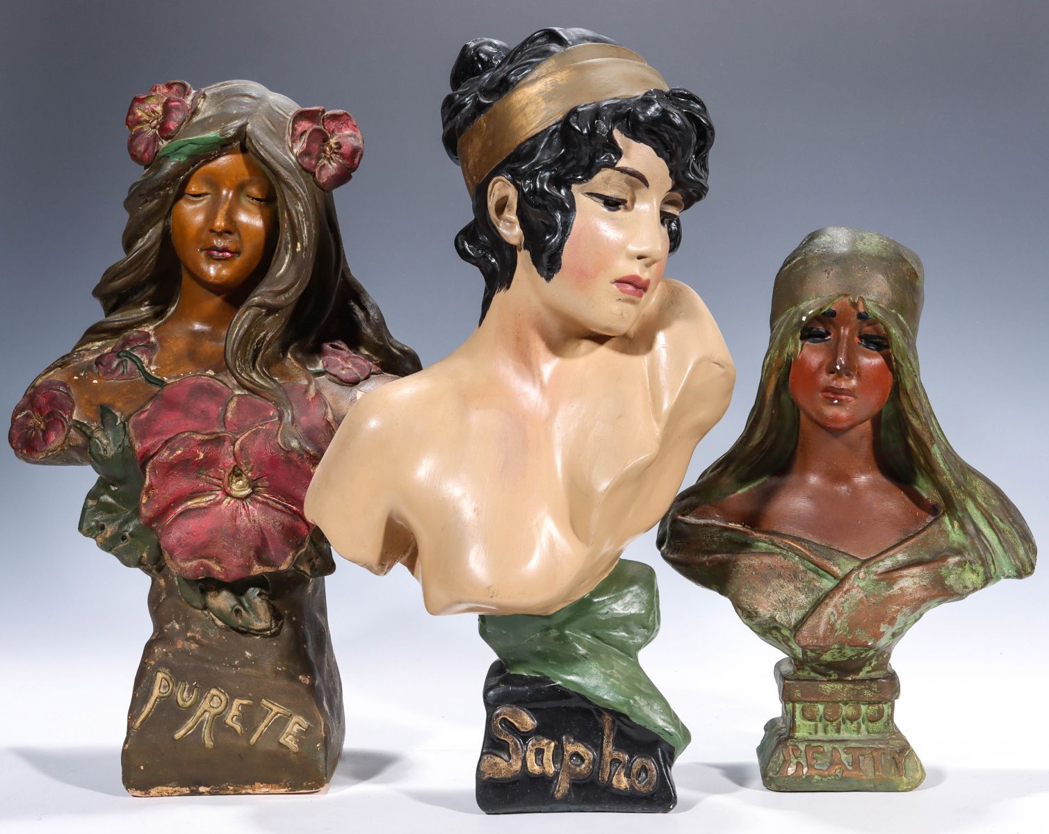 THREE POLYCHROME ENAMEL PLASTER MAIDEN BUST FIGURES