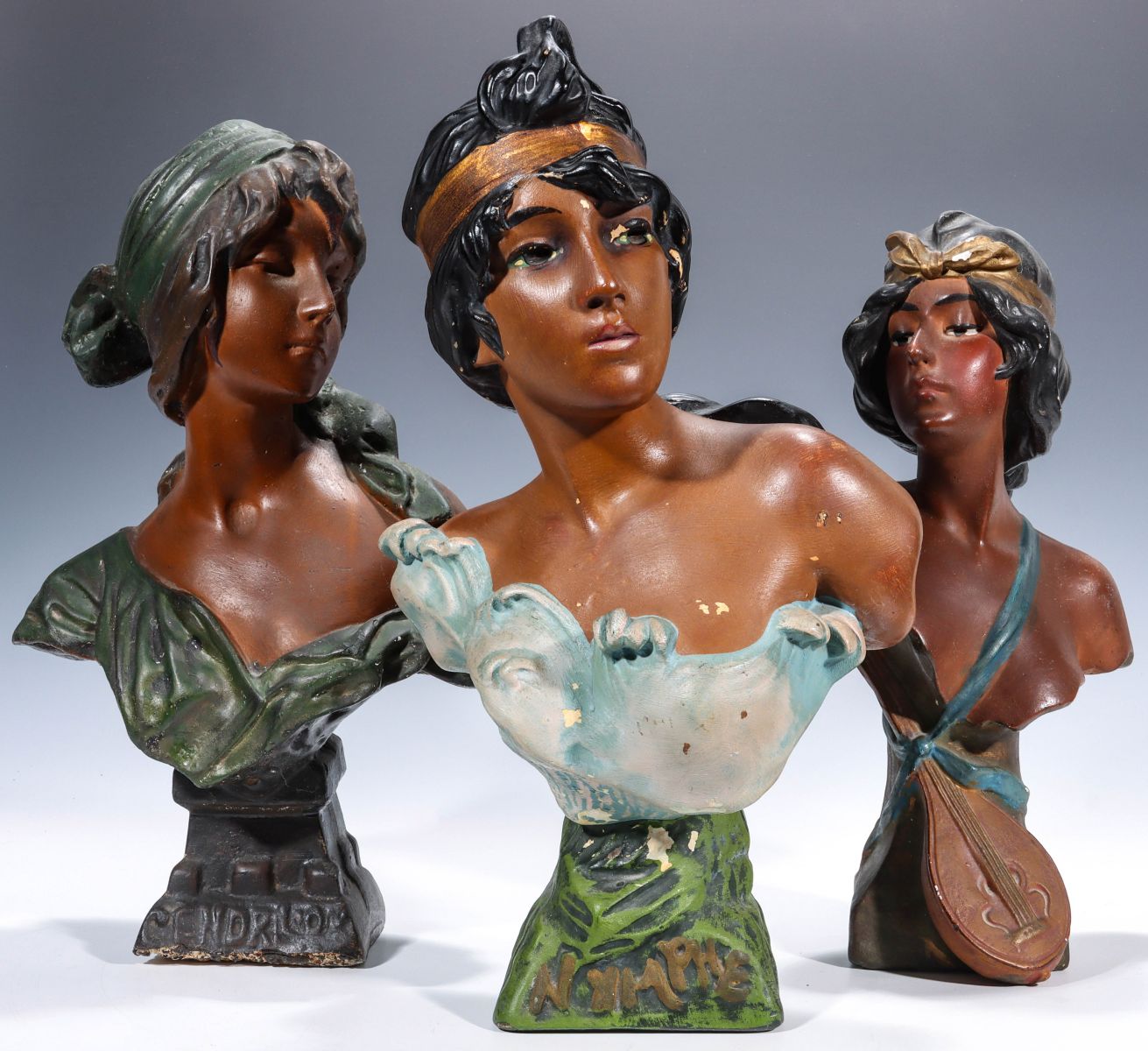 THREE POLYCHROME ENAMEL PLASTER MAIDEN BUST FIGURES