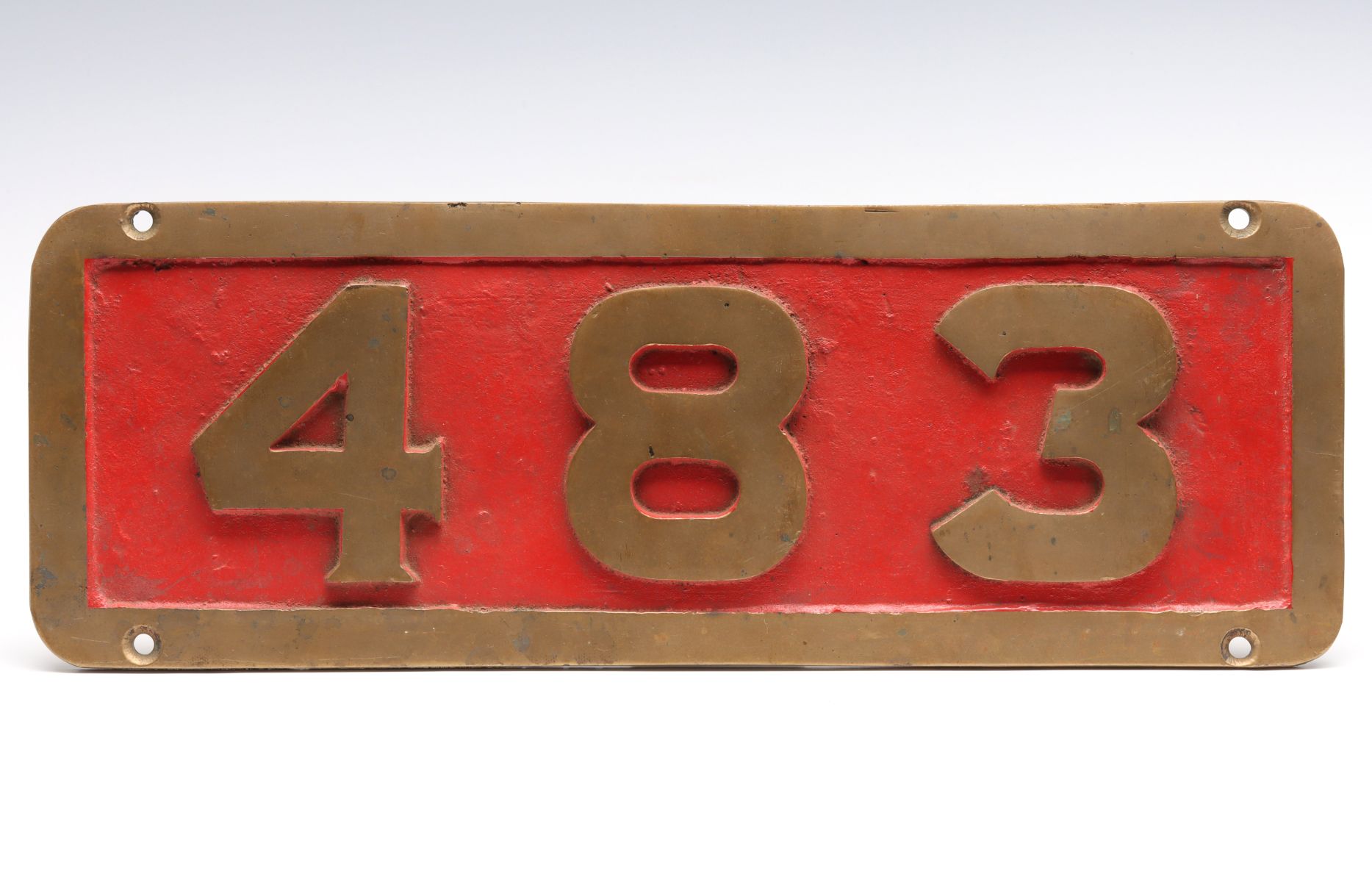 A CAST BRASS OR BRONZE LOCOMOTIVE NUMBER BOARD