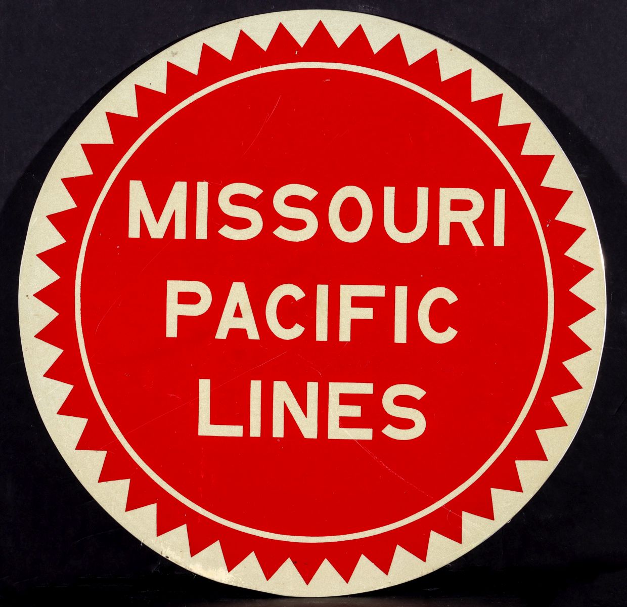 A MISSOURI PACIFIC LINES CIRCULAR PAINTED ALUMINUM SIGN