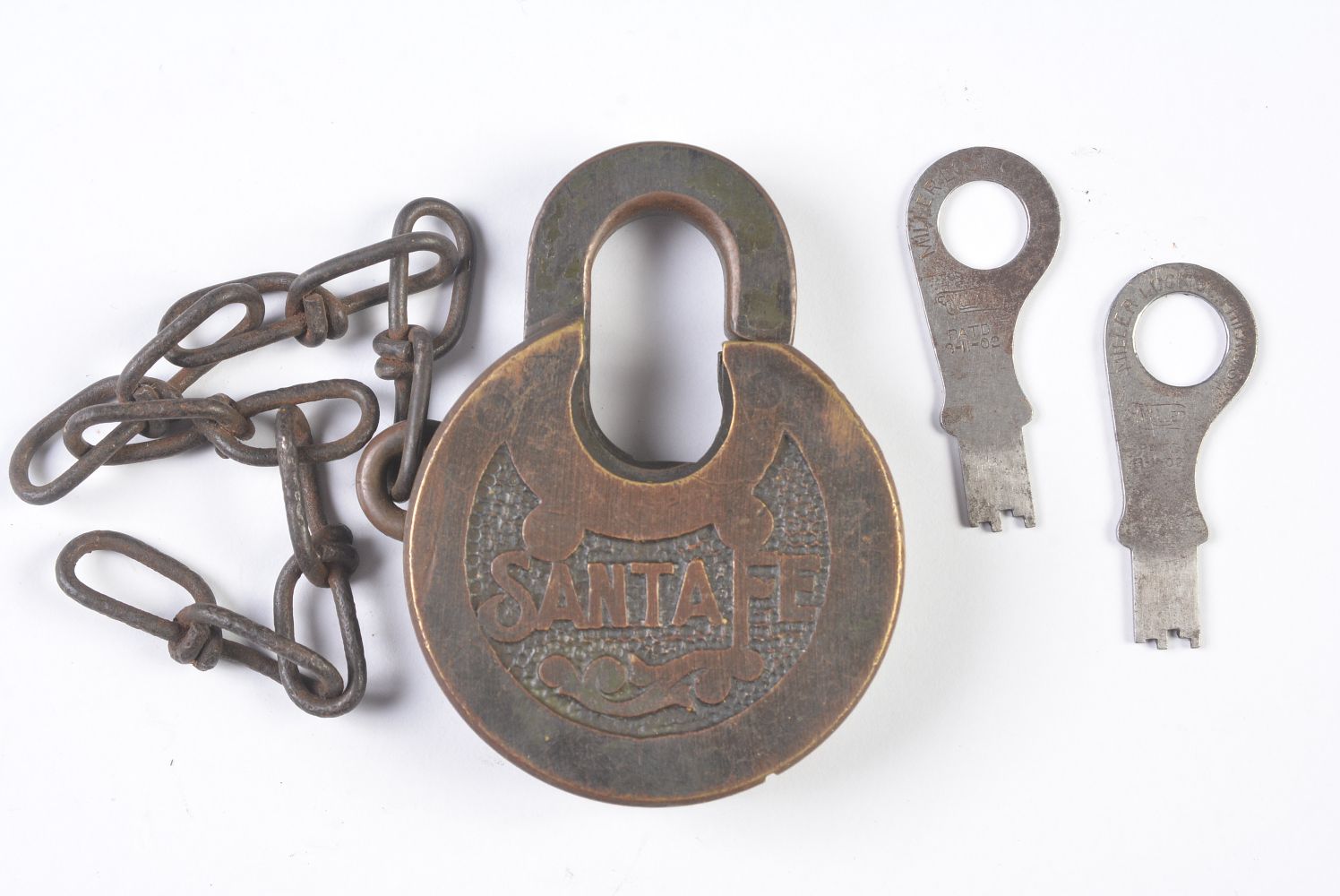 A SANTA FE RAILROAD PANCAKE PADLOCK WITH KEYS