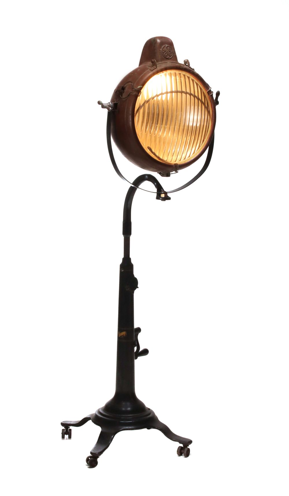 A GE NOVALUX COPPER PROJECTION LIGHT ON IRON STAND