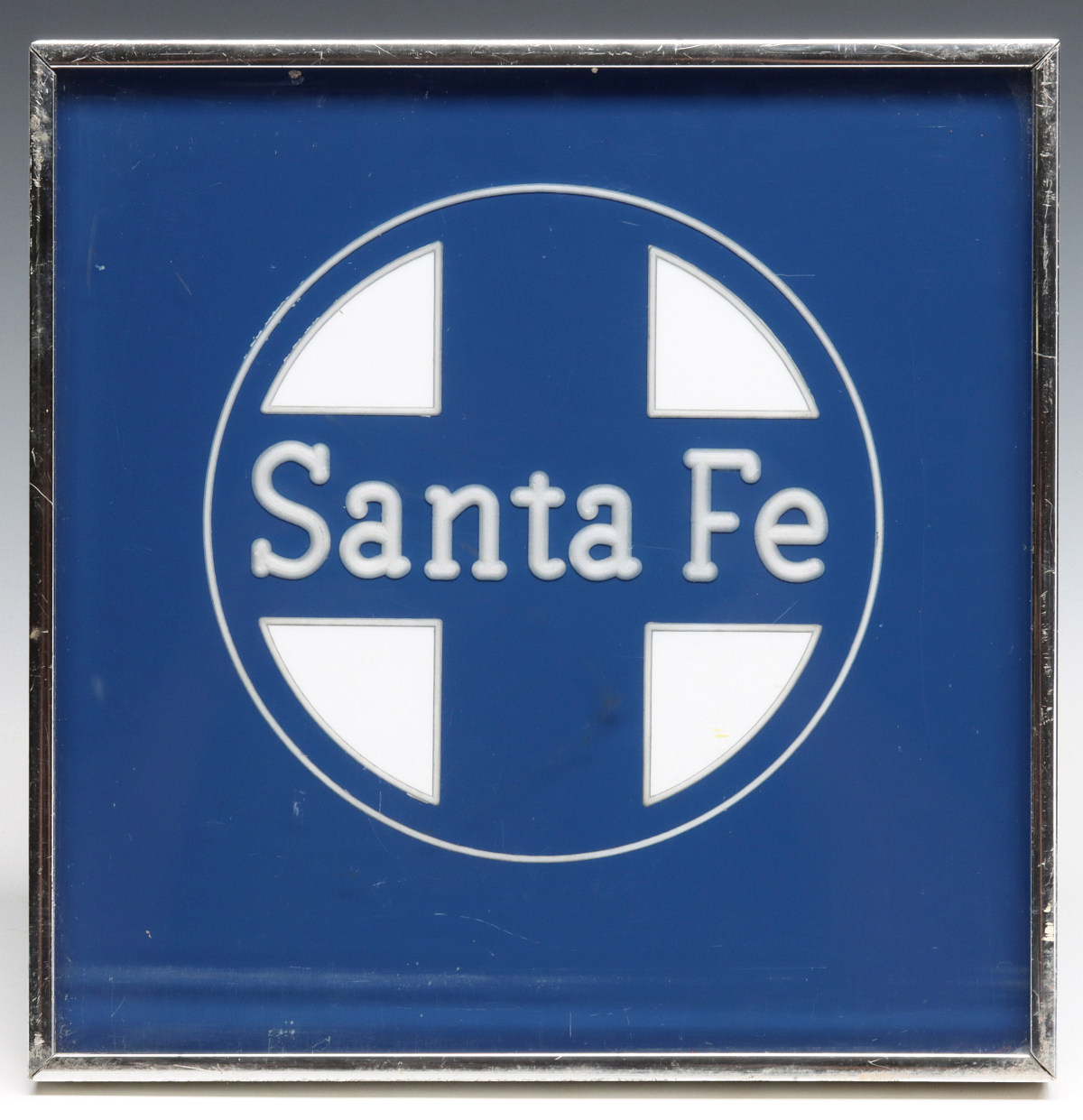 A TWO-TONE SANTA FE LOGO REVERSE CARVED IN ACRYLIC