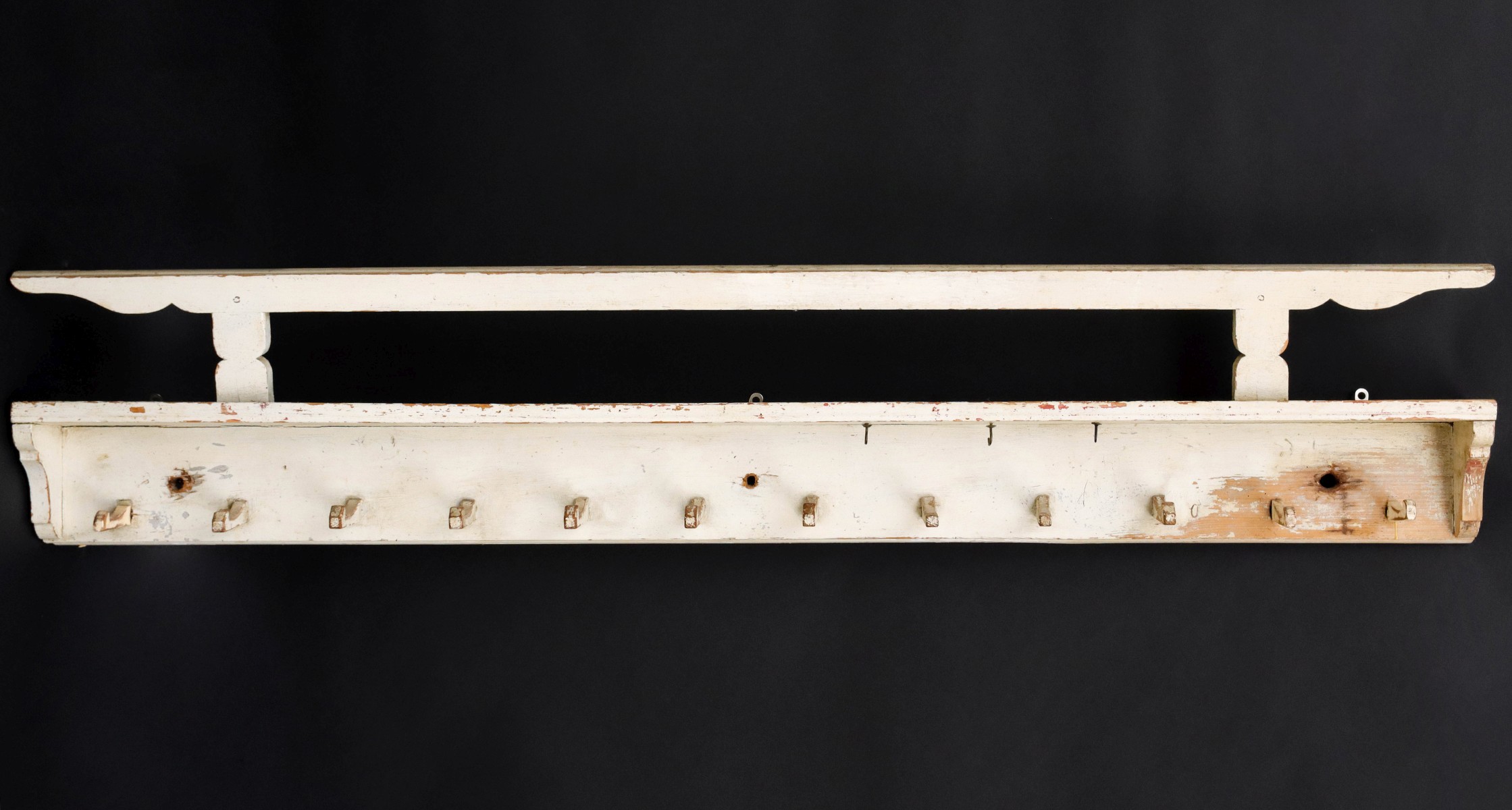 A PINE HERB DRYING RACK WITH CARVED WOOD HOOKS