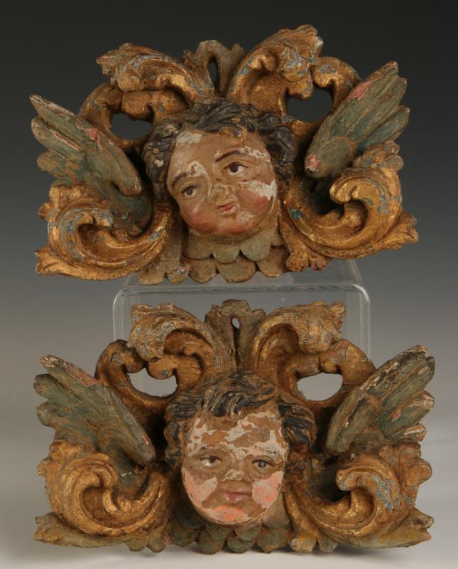A PAIR EARLY 19TH C. CARVED OAK CHERUB FACE ORNAMENTS
