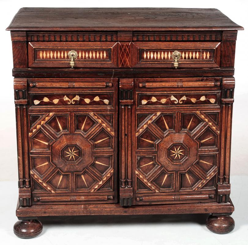 A JACOBEAN OAK CUPBOARD WITH INLAID BONE DECORATION