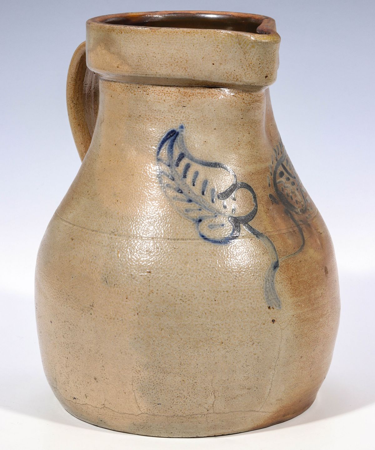 A BLUE DECORATED STONEWARE MILK PITCHER