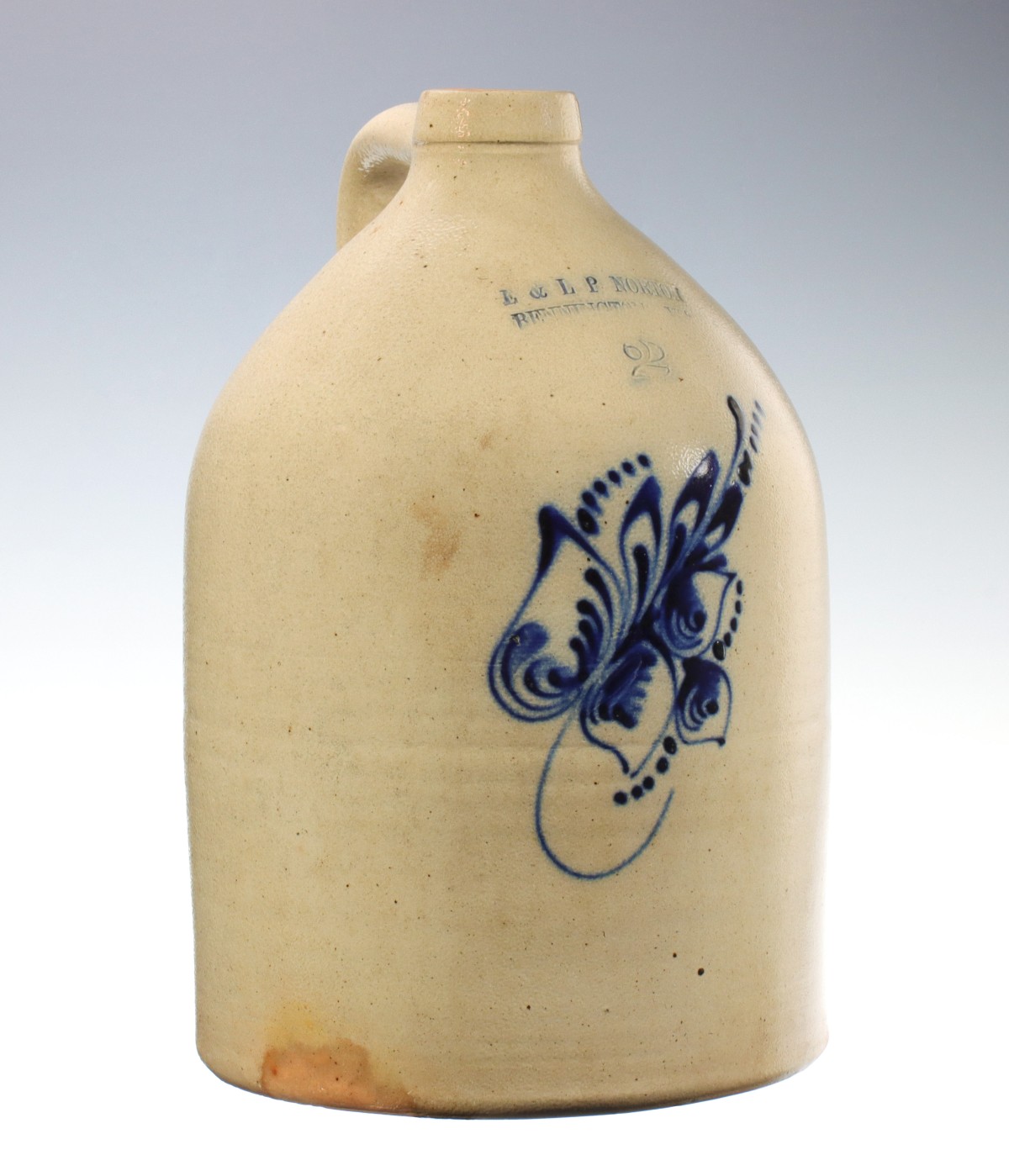 A BLUE DECORATED STONEWARE JUG SIGNED NORTON