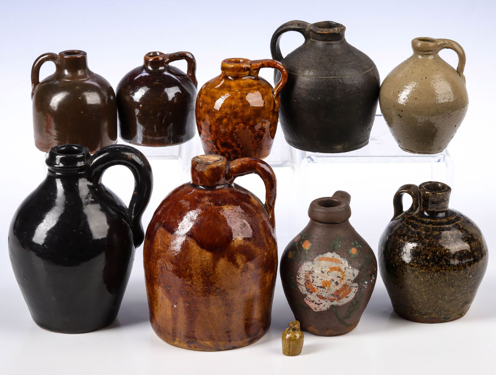 TEN MINIATURE STONEWARE JUGS CIRCA 1910