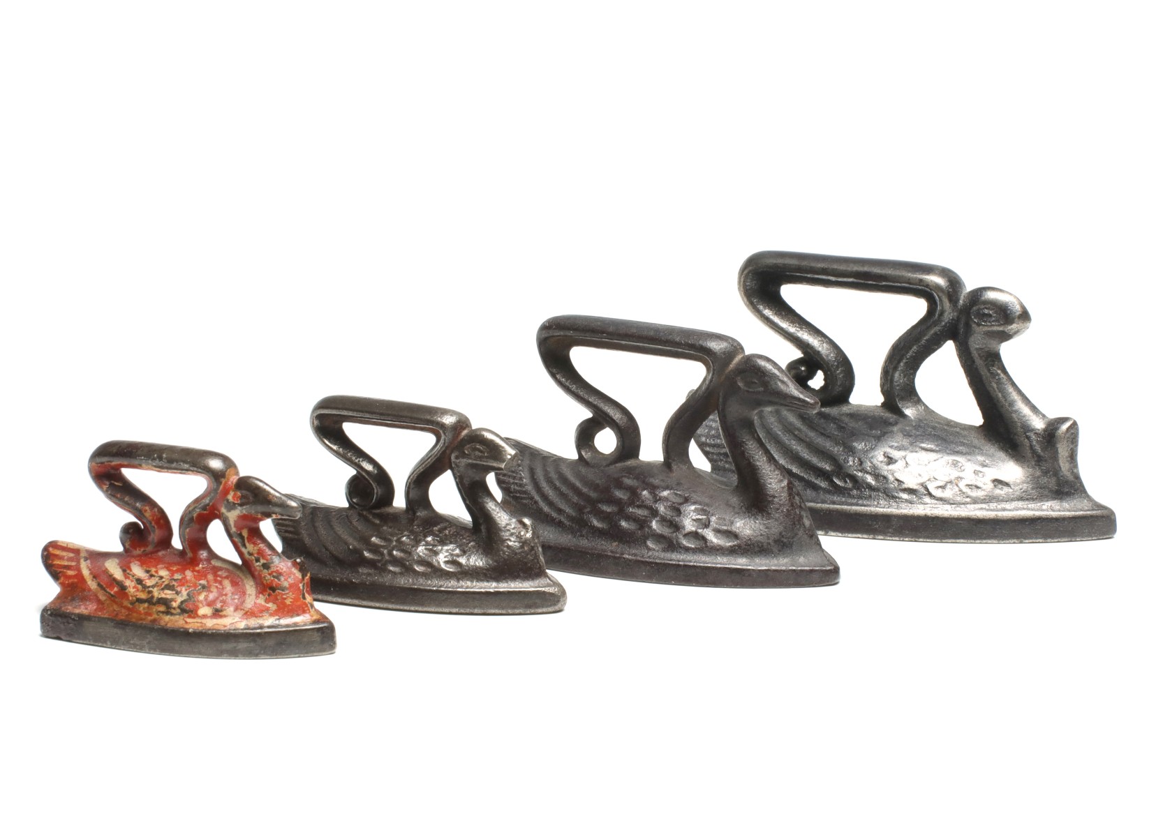FOUR FIGURAL SWAN SAD IRON MINIATURES