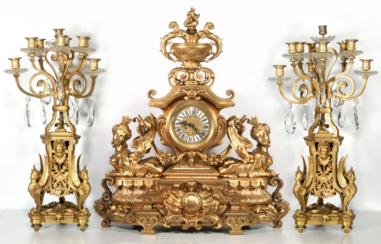 A MONUMENTAL DORÉ GARNITURE CLOCK SET WITH FIGURES