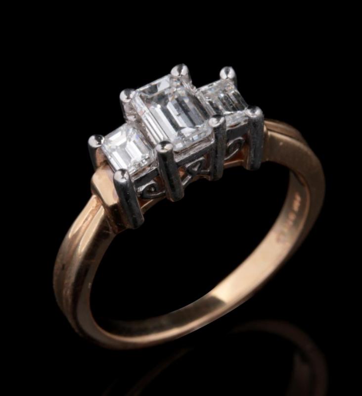 A 14K ENGAGEMENT RING WITH THREE EMERALD CUT DIAMONDS