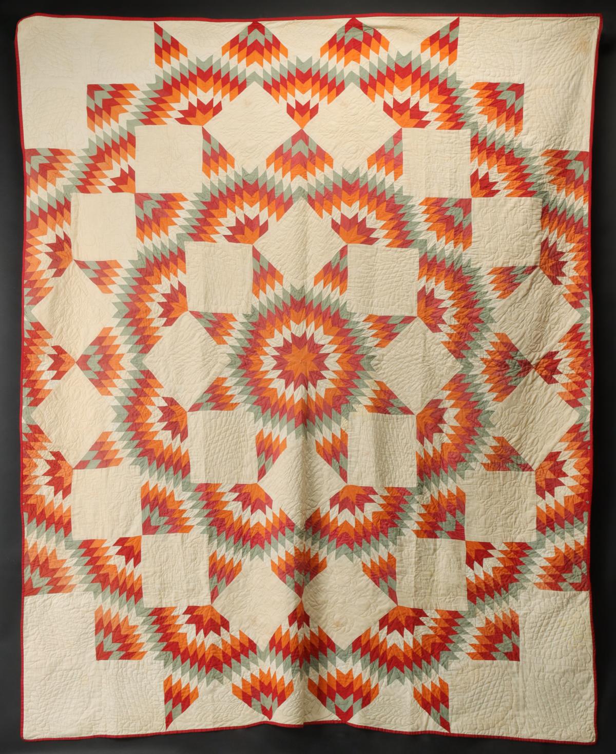 ANTIQUE QUILT IN THE 'BROKEN STAR' PATTERN