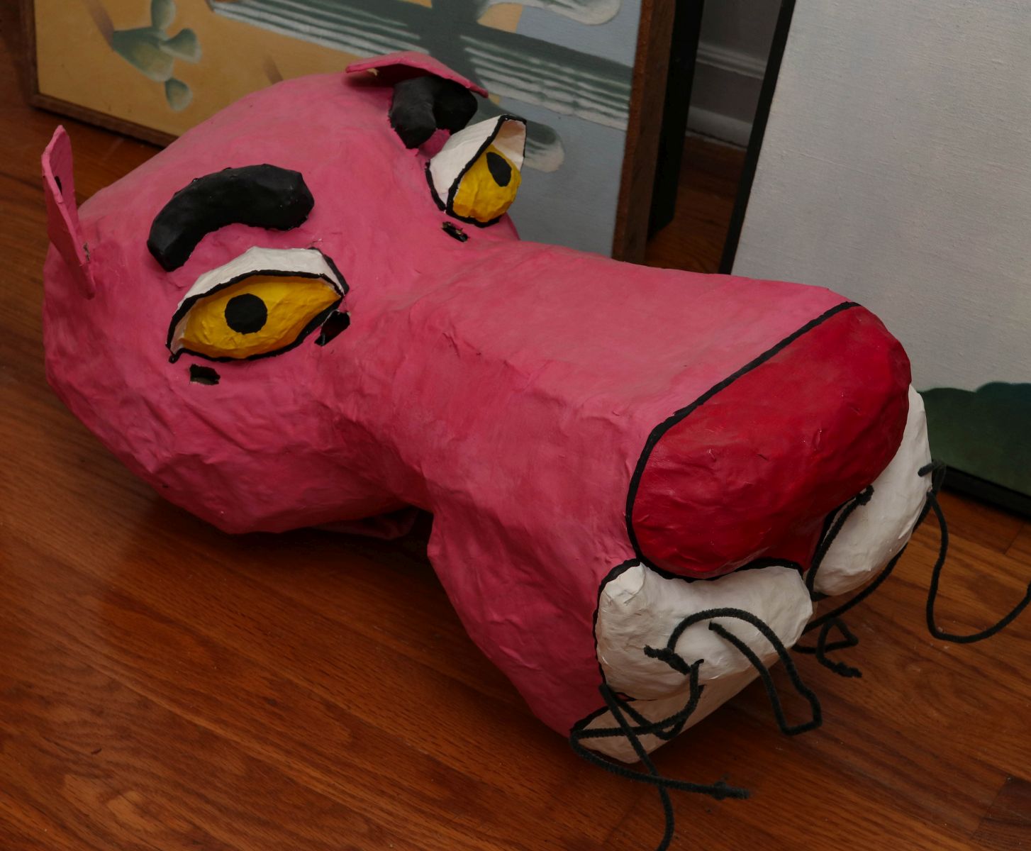 AN OUTSIZED PAPIER MACHE PINK PANTHER MASK