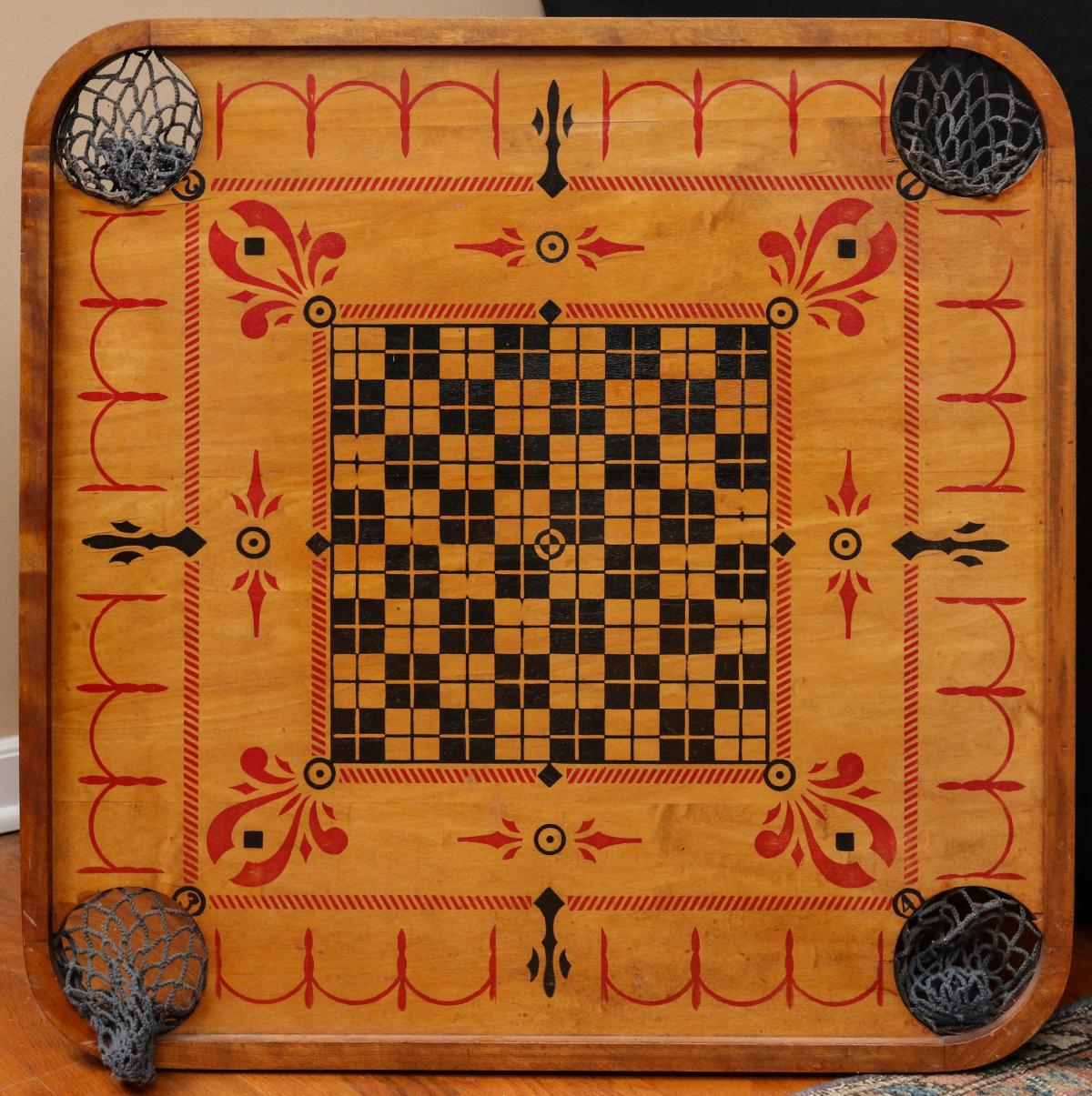 AN ANTIQUE CARROM BOARD CIRCA 1902