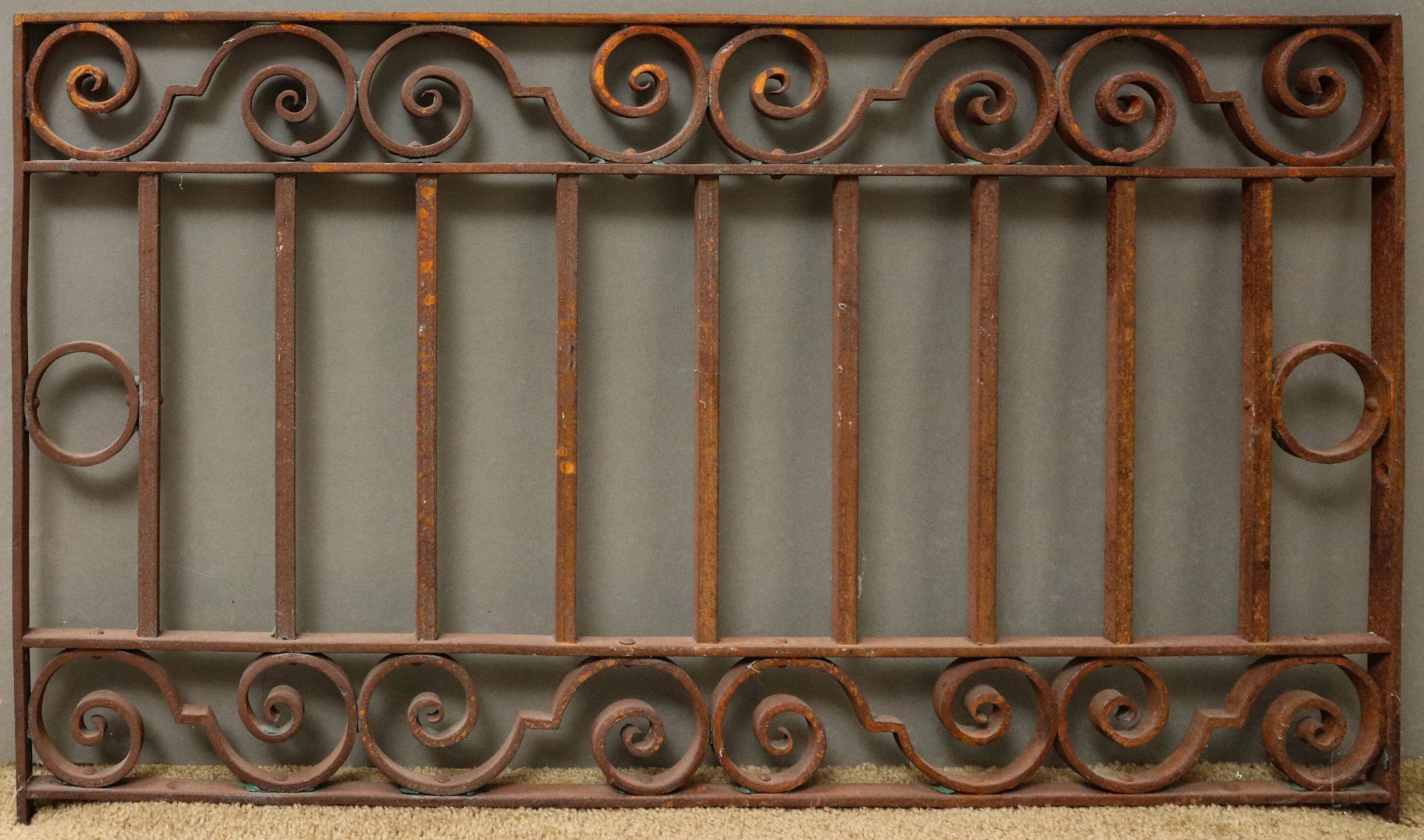 AN ANTIQUE IRON ARCHITECTURAL ORNAMENT