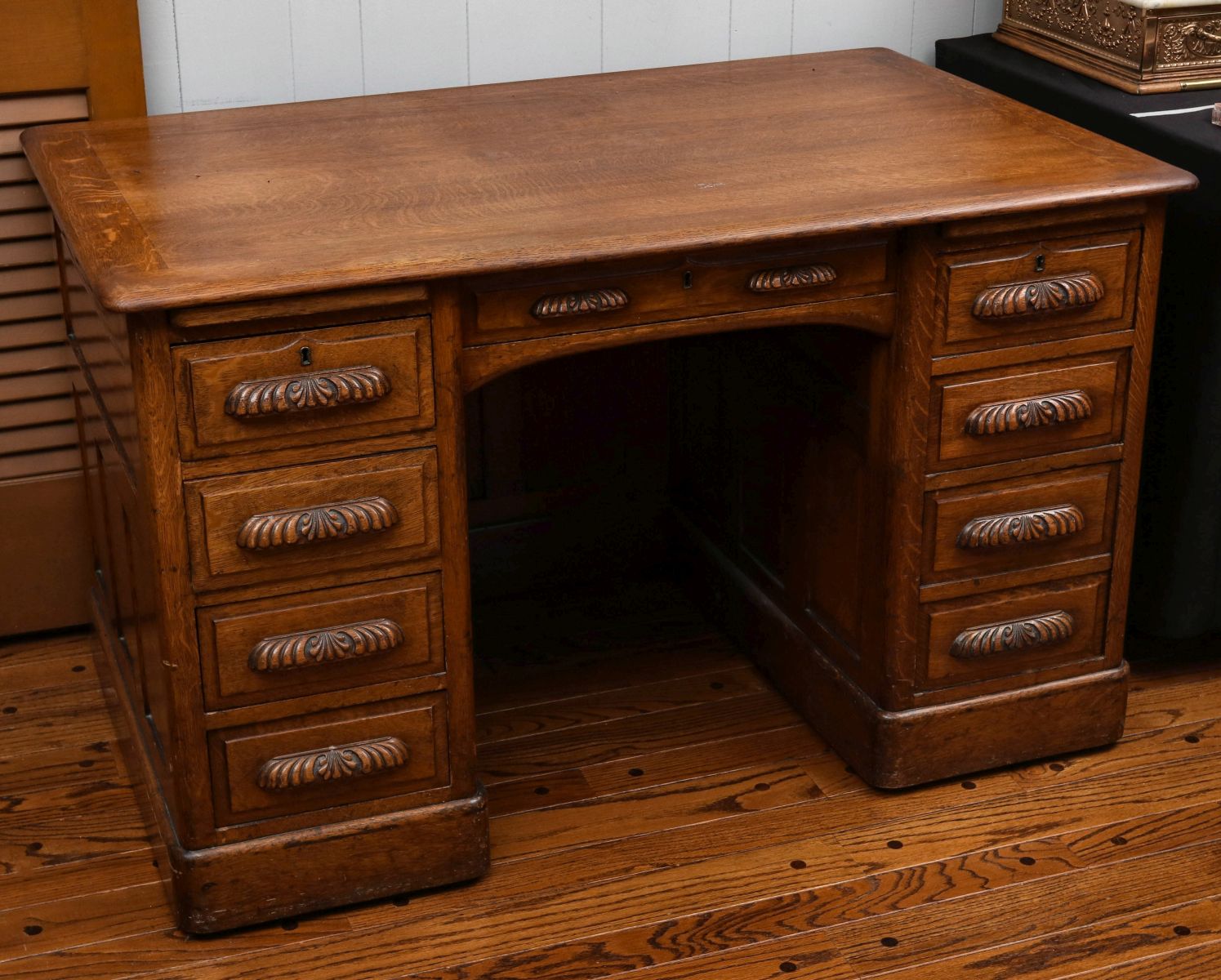 A CIRCA 1900 OAK DESK W/ FANCY CARVED DRAWER PULLS