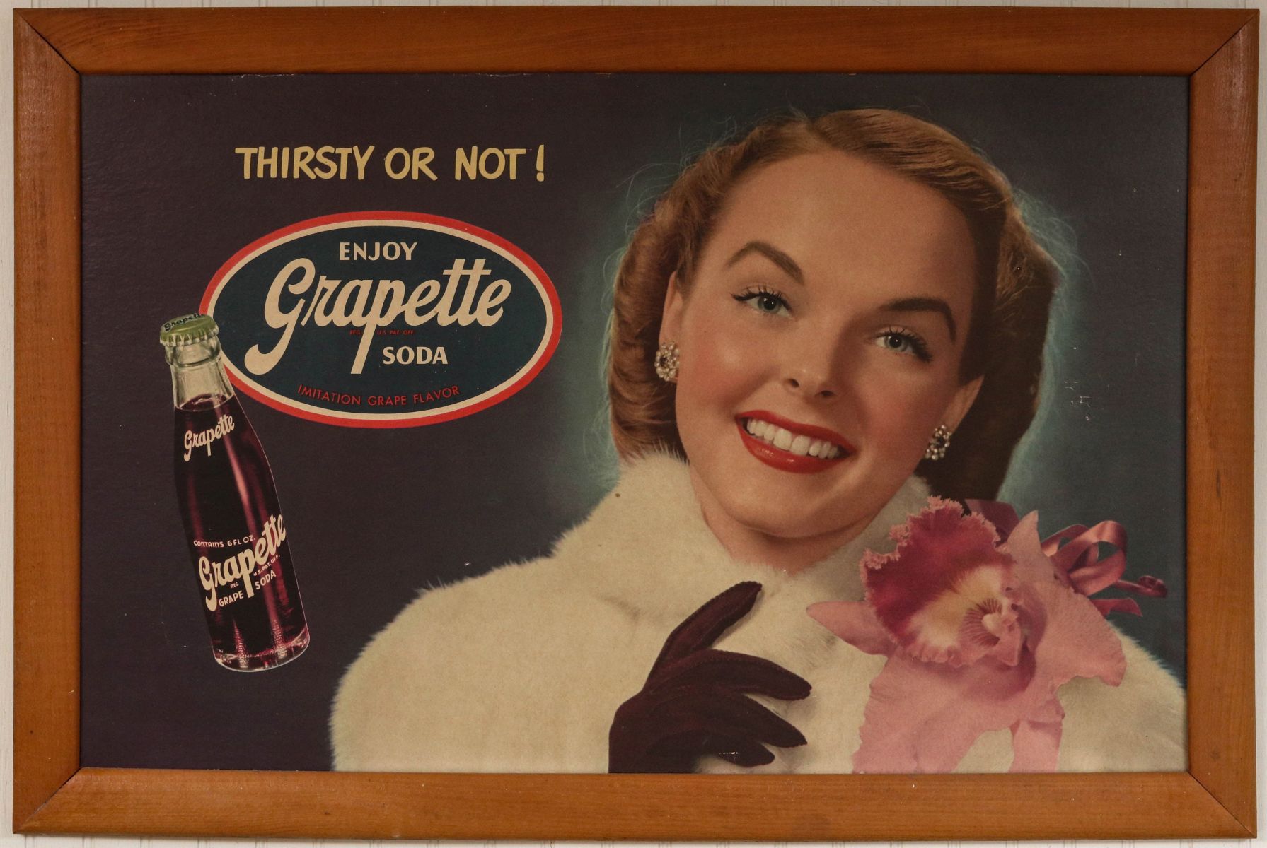 A 1940s GRAPETTE SODA CARDBOARD ADVERTISING SIGN