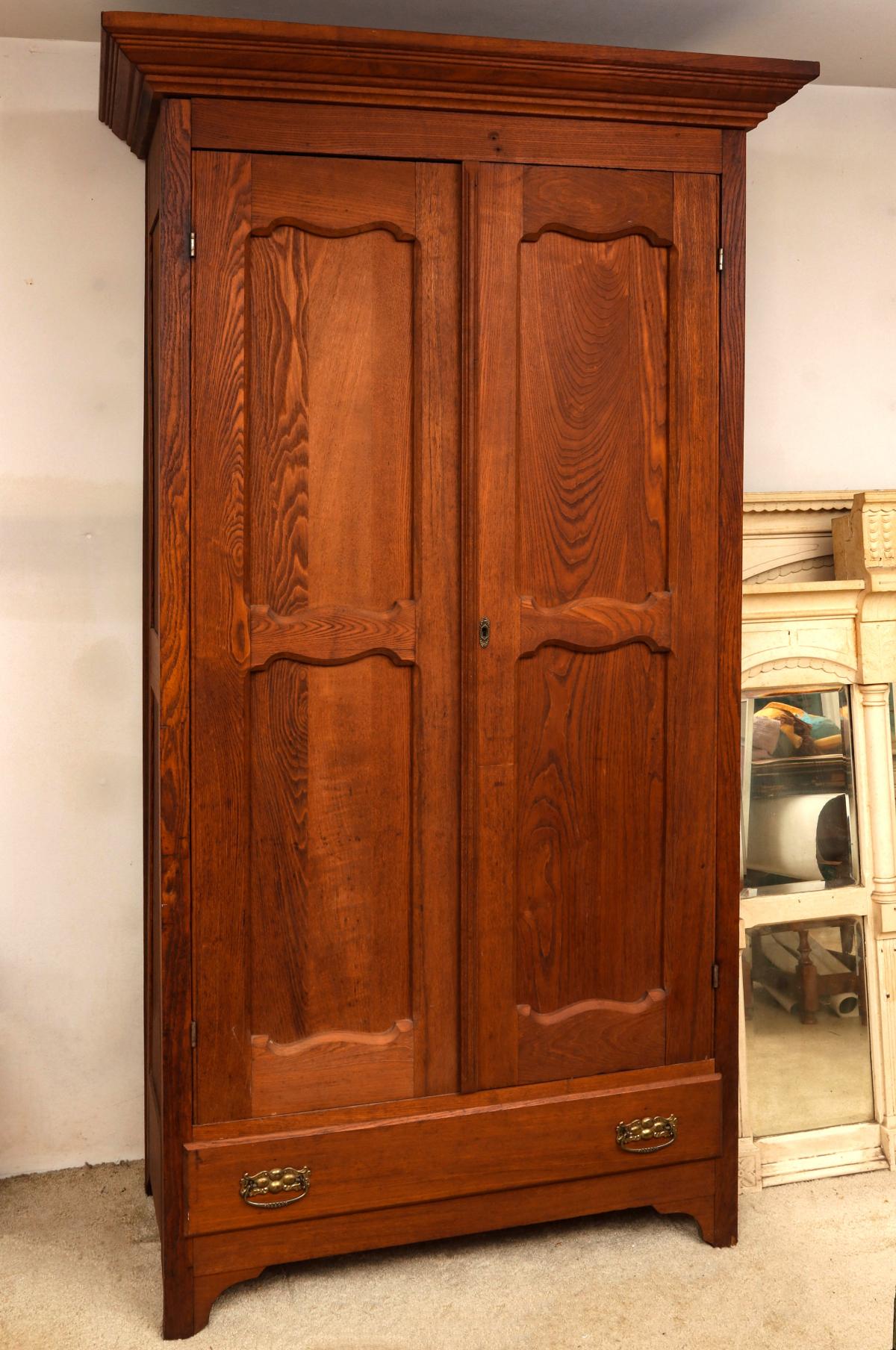 A CIRCA 1900 ASH TWO DOOR ARMOIRE