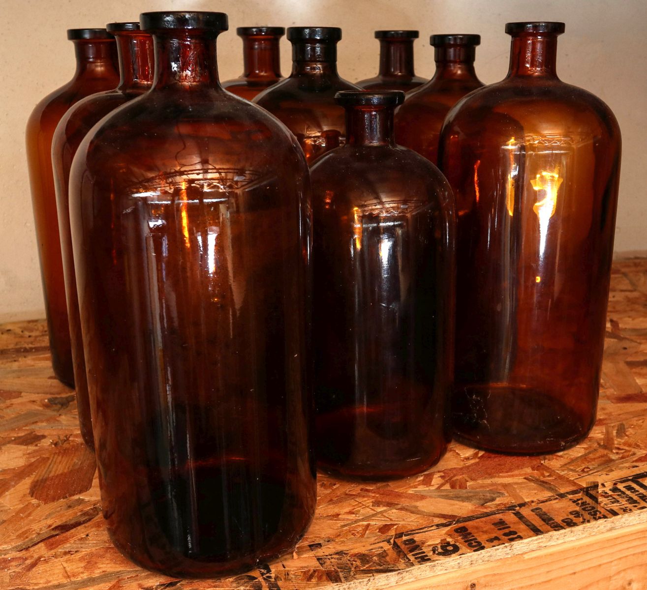 NINE LARGE EARLY 20TH CENT AMBER MEDICINE BOTTLES