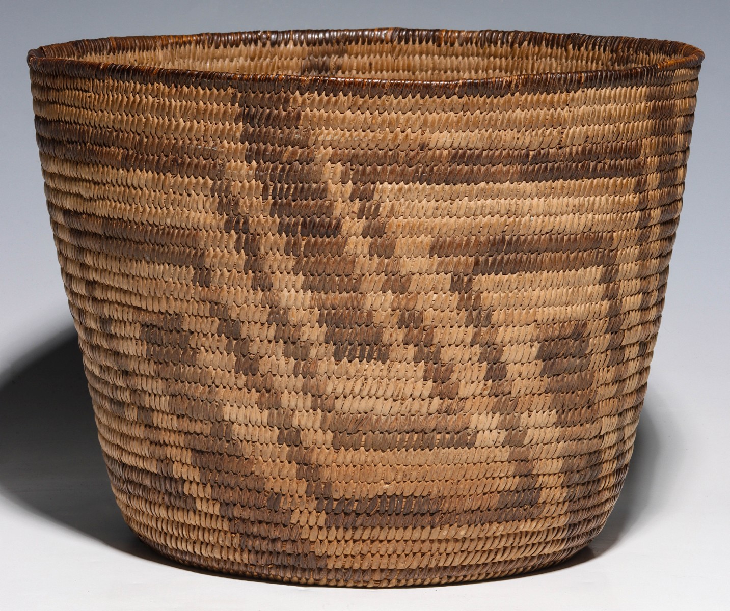A PAPAGO BASKET WITH INTERLOCKING ZIG ZAGS