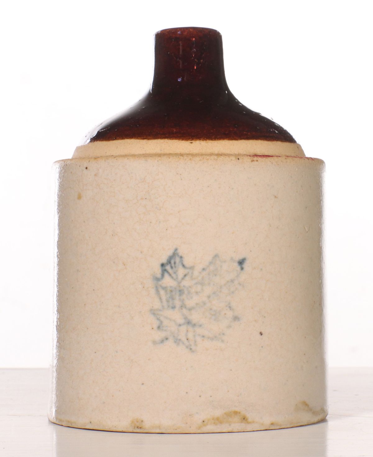 A WESTERN STONEWARE JUG-FORM STRING HOLDER WITH LEAF