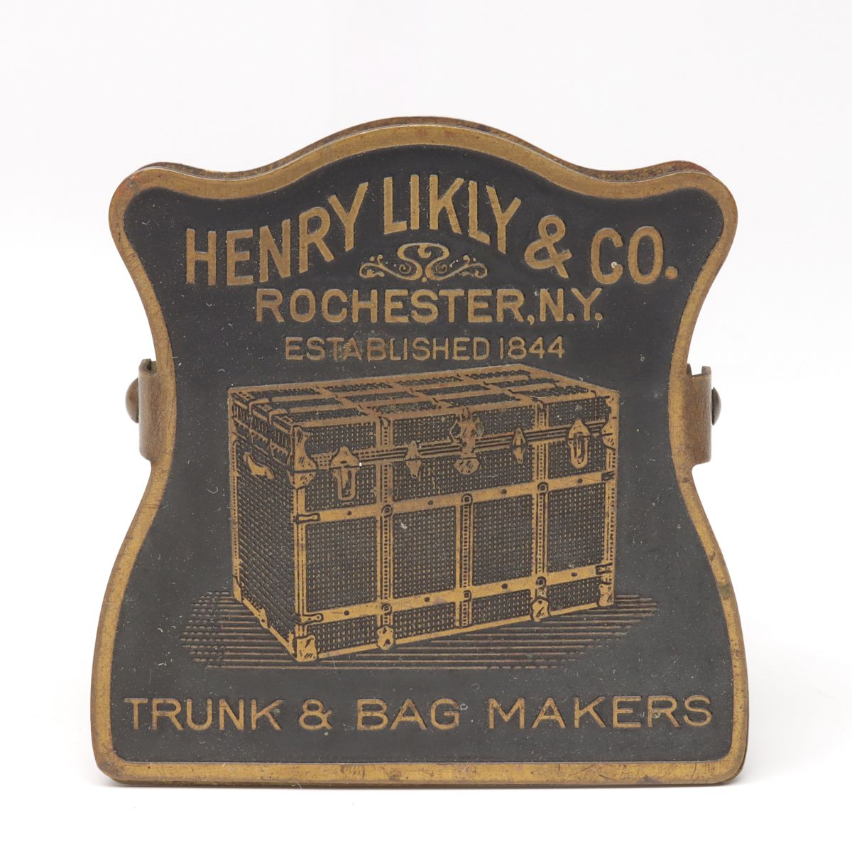 A 1910s TRUNK MAKER DETAILED PICTORIAL BRASS BILL CLIP