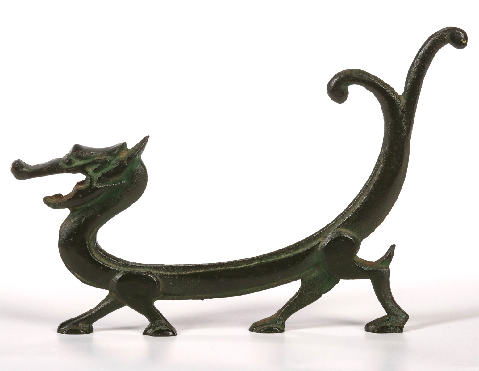 A VINTAGE STYLIZED DRAGON PATINATED IRON BOTTLE OPENER