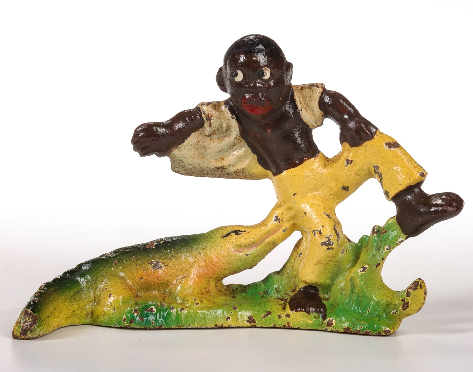 A VINTAGE FIGURAL IRON BOTTLE OPENER