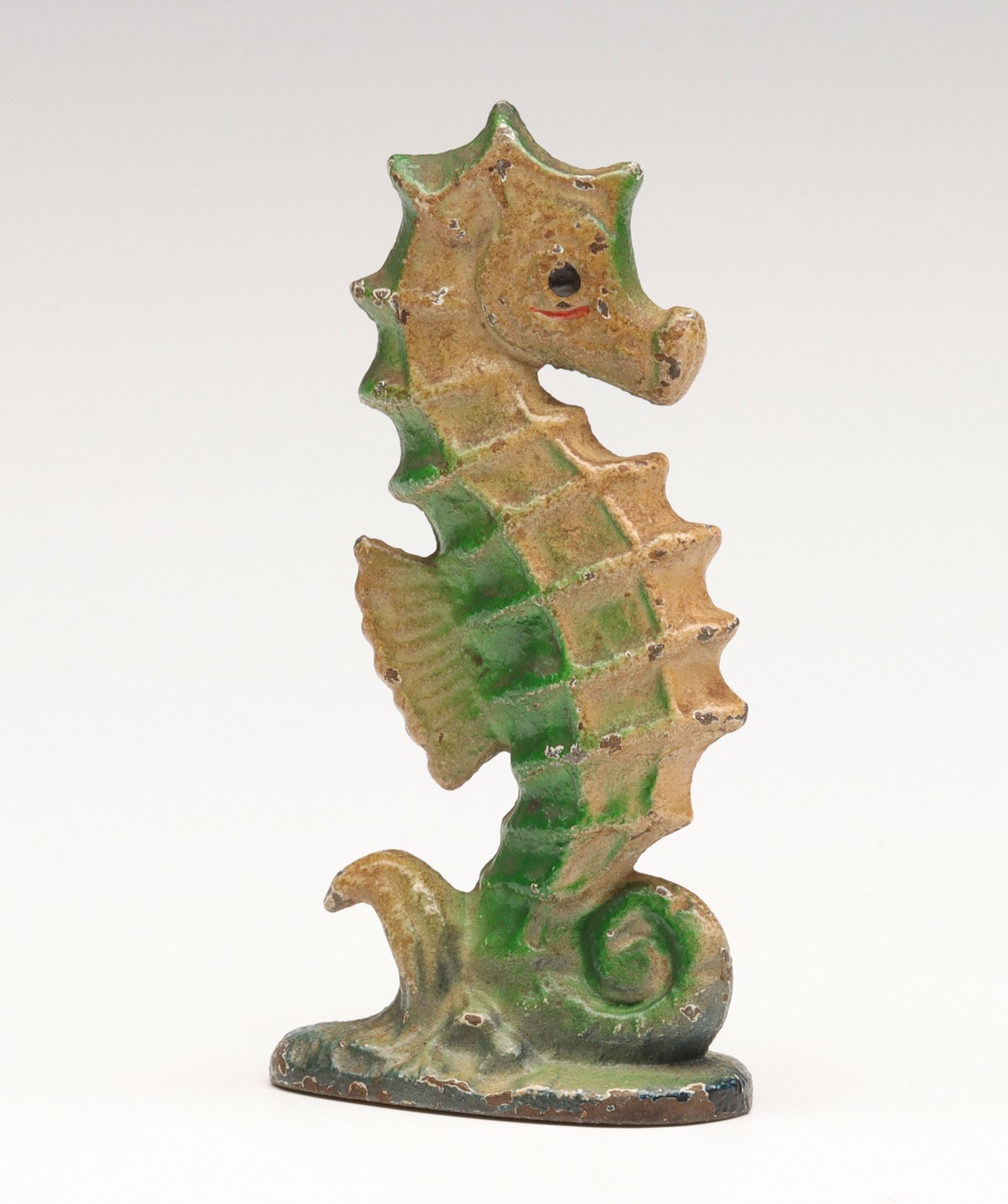 A VINTAGE FIGURAL SEAHORSE IRON BOTTLE OPENER