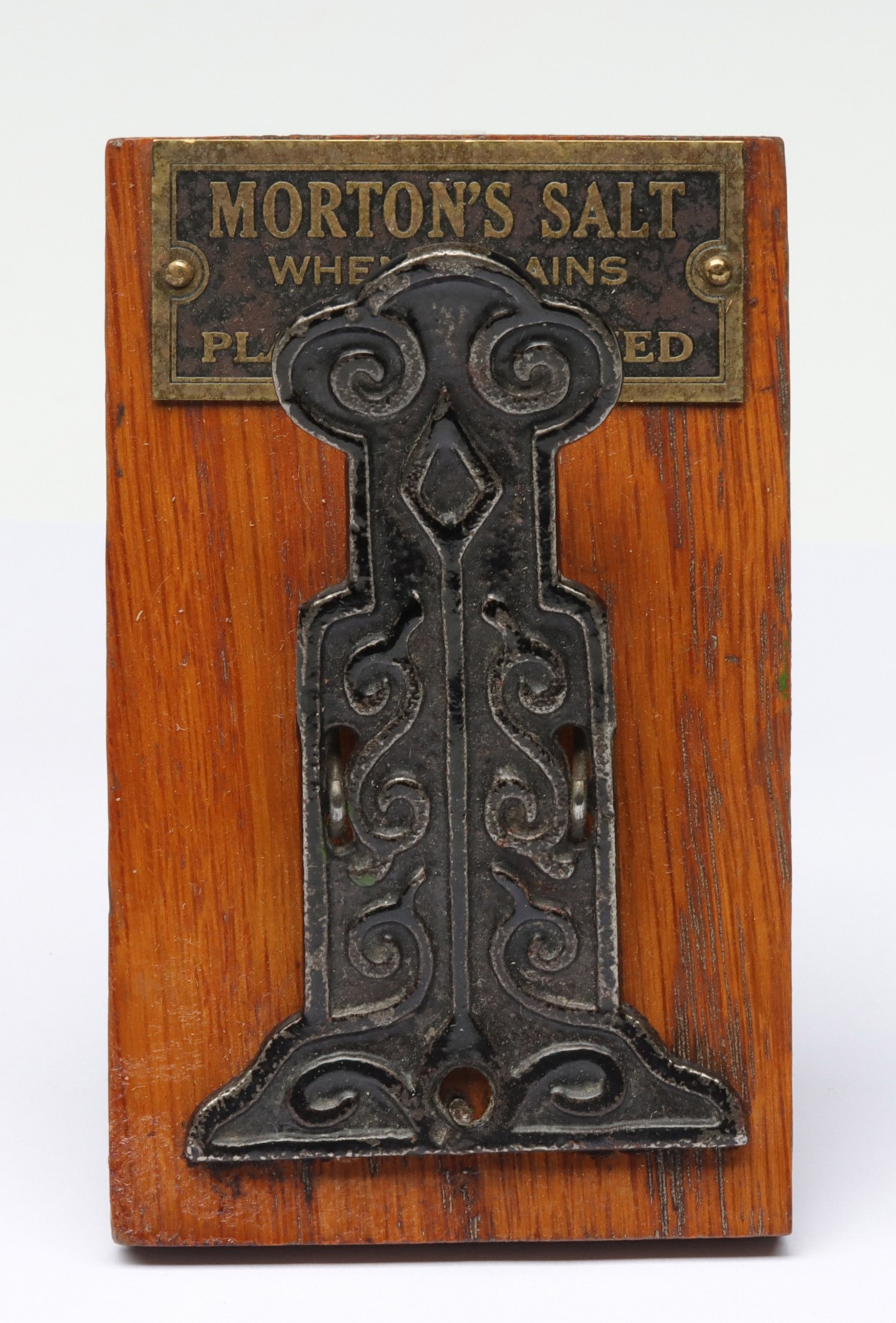 A MORTON'S SALT ORNATE IRON AND WOOD LETTER CLIP