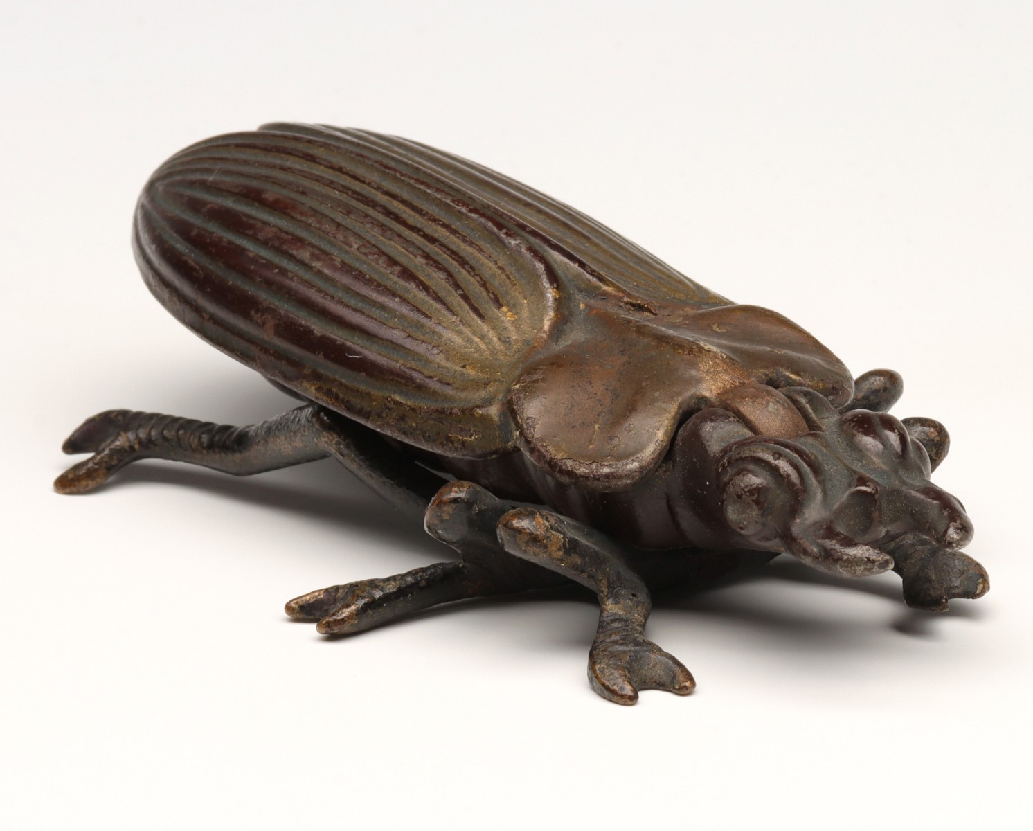 A DETAILED CAST IRON BEETLE MATCH SAFE WITH BRASS