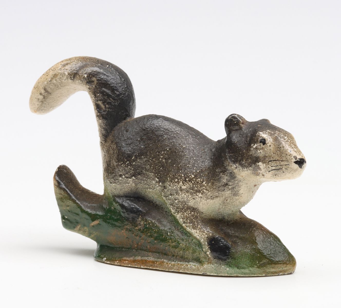 A VINTAGE FIGURAL SQUIRREL IRON BOTTLE OPENER