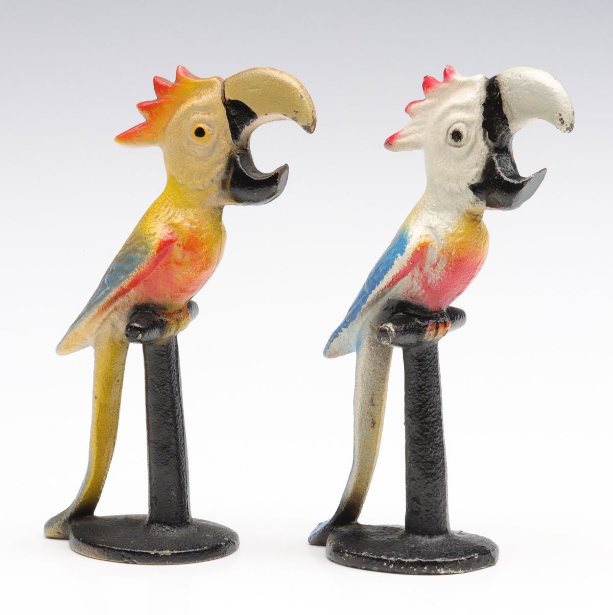 TWO DIFFERENT FIGURAL PARROT IRON BOTTLE OPENERS