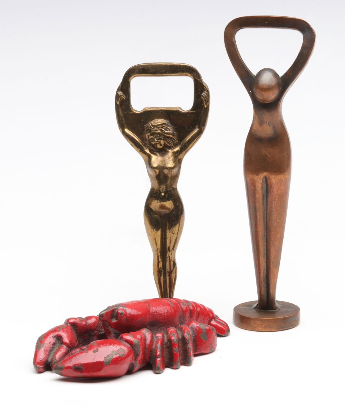 THREE VINTAGE FIGURAL IRON BOTTLE OPENERS