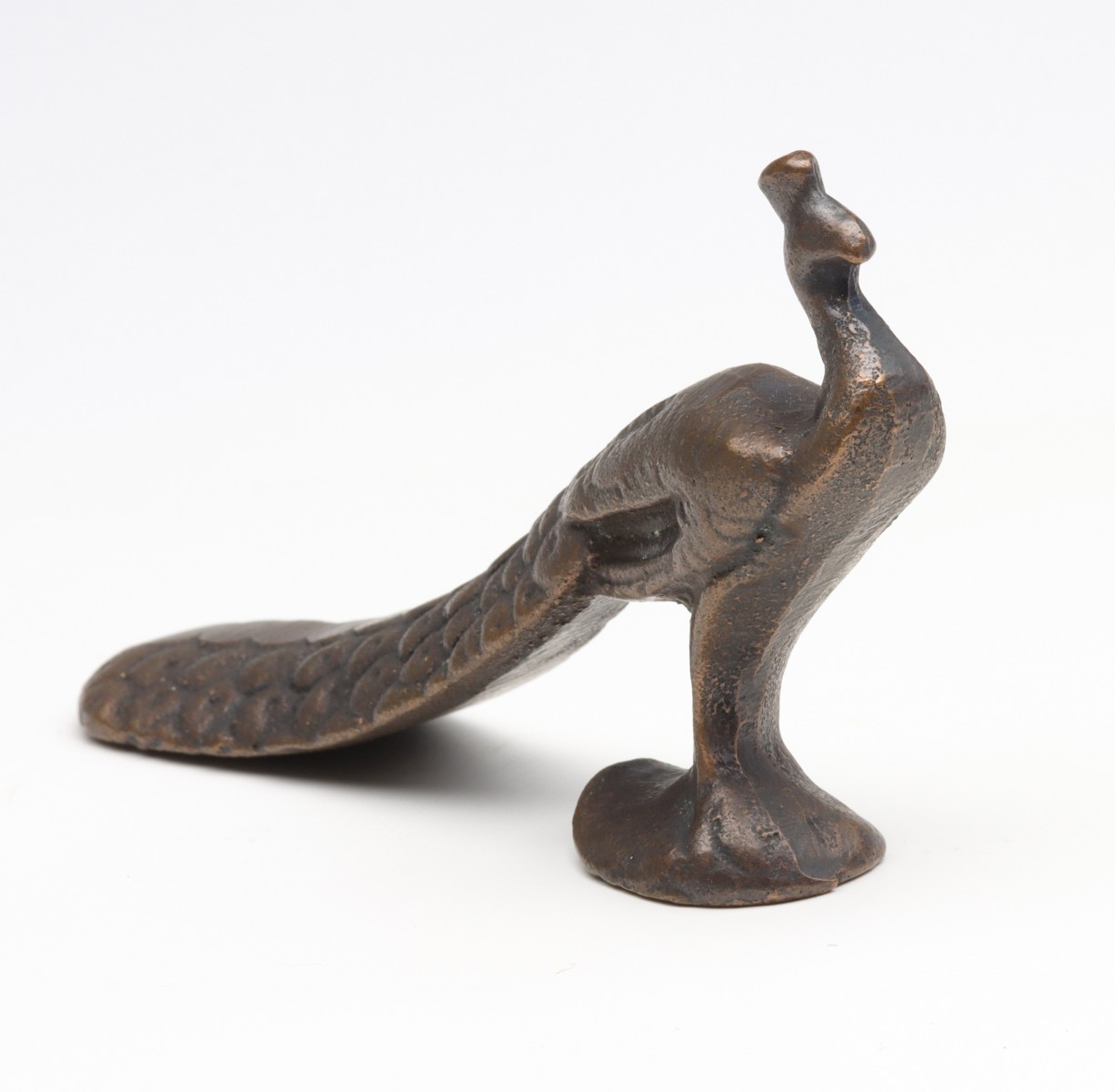 A VINTAGE FIGURAL PEACOCK IRON BOTTLE OPENER