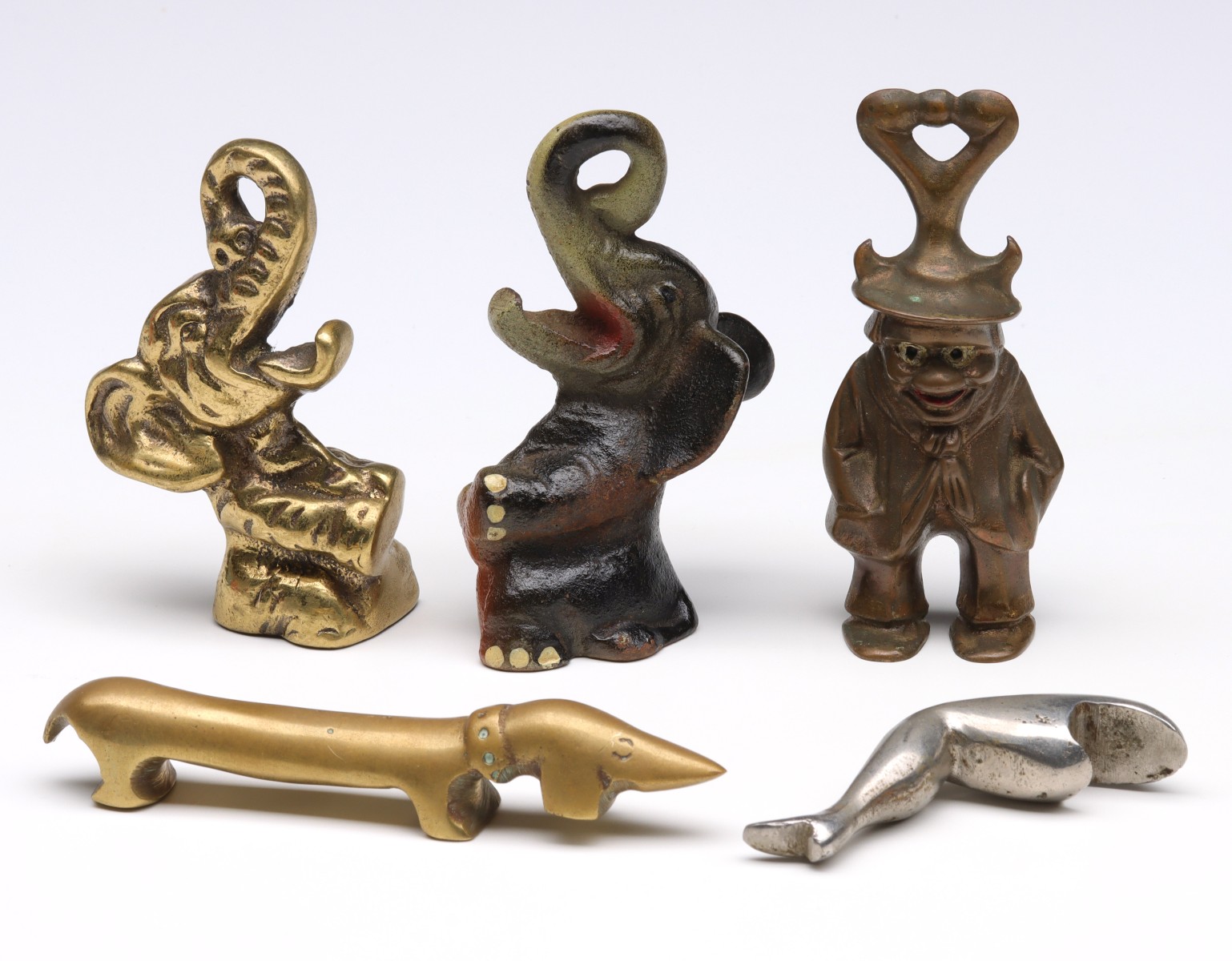 FIVE VINTAGE FIGURAL IRON BOTTLE OPENERS