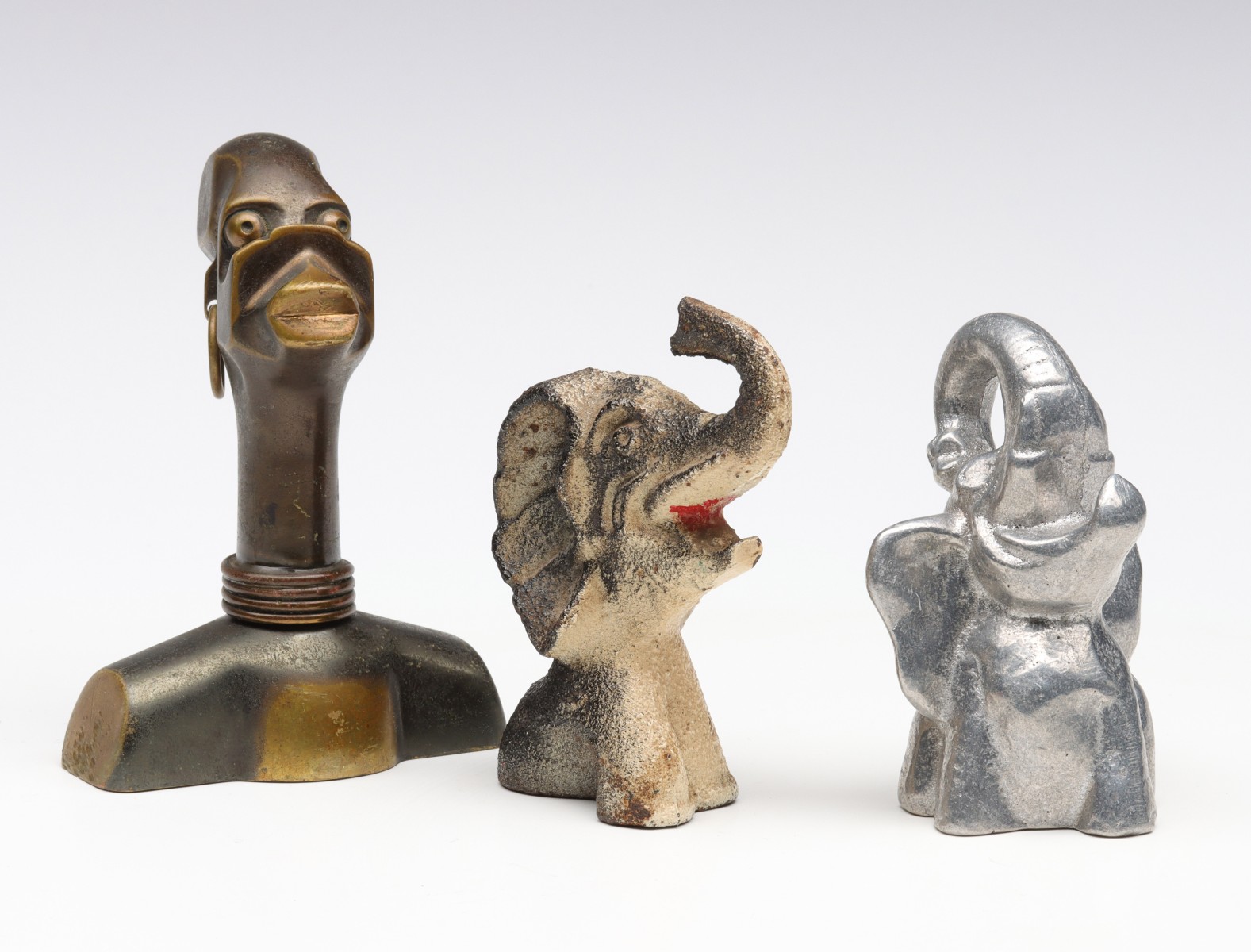 THREE UNUSUAL FIGURAL IRON BOTTLE OPENERS