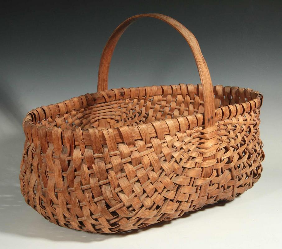 AN OAK SPLINT BASKET BY THE WESTFALLS, BUFFALO MO