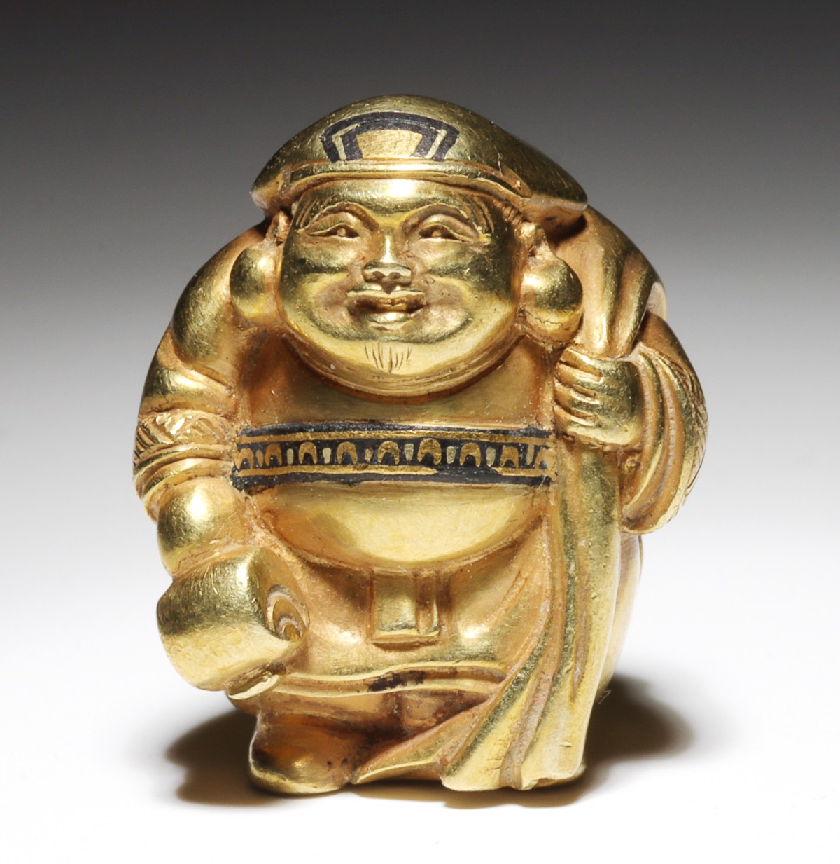 A MEIJI PERIOD HIGH KARAT GOLD OJIME MODEL OF DAIKOKU