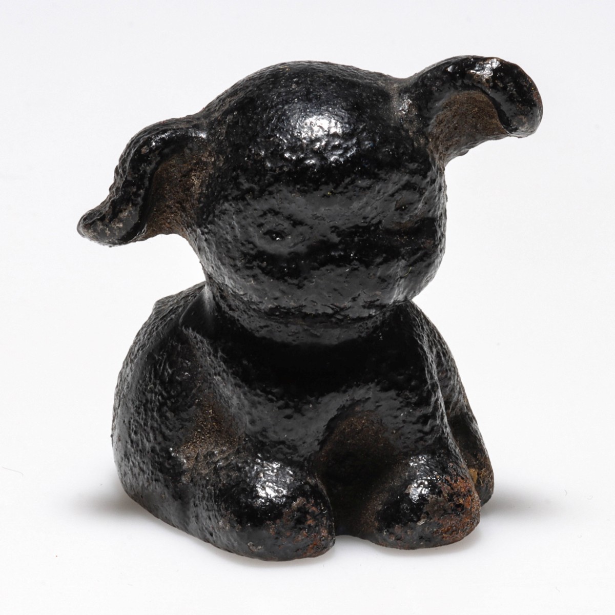 A FIGURAL PUP IRON PAPERWEIGHT LETTERED EAST TECH