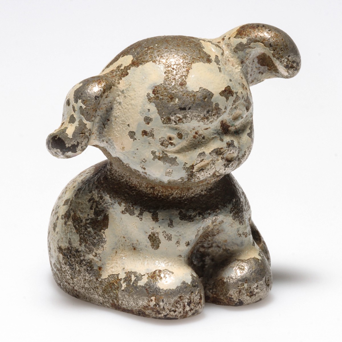 A FIGURAL PUP CAST IRON ADVERTISING PAPERWEIGHT